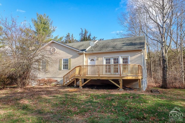 rear view of property featuring a yard and a wooden deck