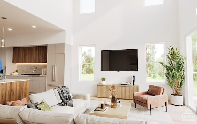 living room featuring a wealth of natural light, a high ceiling, and recessed lighting