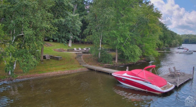 dock area with a lawn and a water view