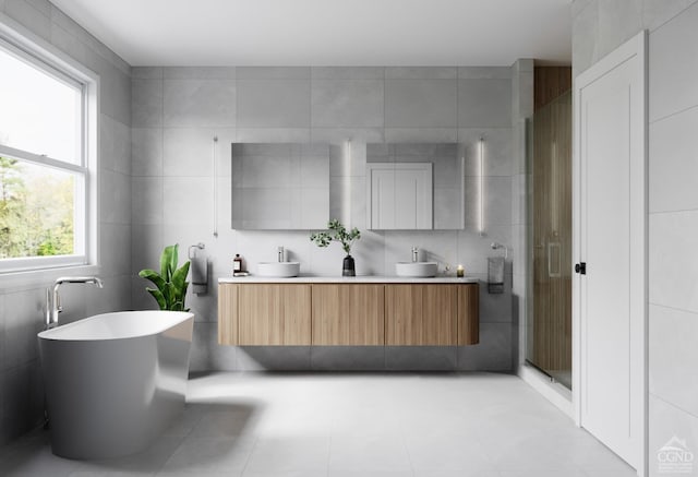 bathroom featuring tile walls, double vanity, a shower stall, and a sink