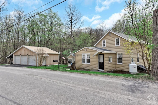 view of front of property with a garage and an outdoor structure