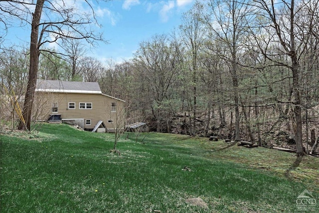 view of yard with a view of trees