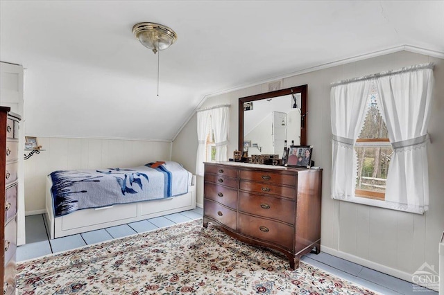 tiled bedroom featuring baseboards and lofted ceiling