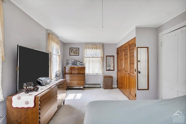 bedroom with baseboard heating, ornamental molding, and light carpet
