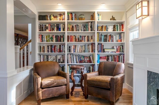 living area featuring built in features and light hardwood / wood-style flooring