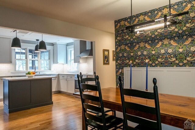 dining room with light hardwood / wood-style floors and sink