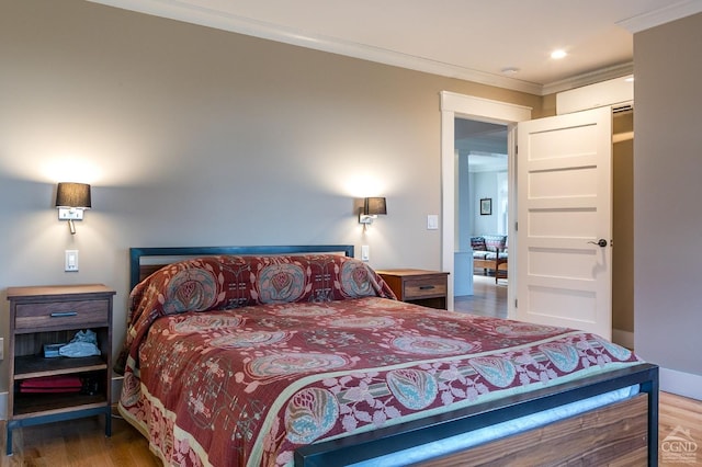 bedroom with crown molding and hardwood / wood-style floors