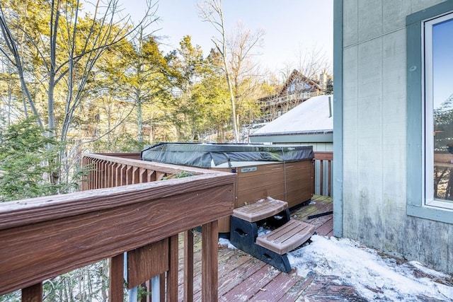 snow covered deck with a hot tub