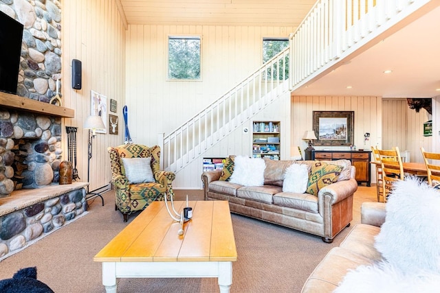 living room with light carpet and a towering ceiling