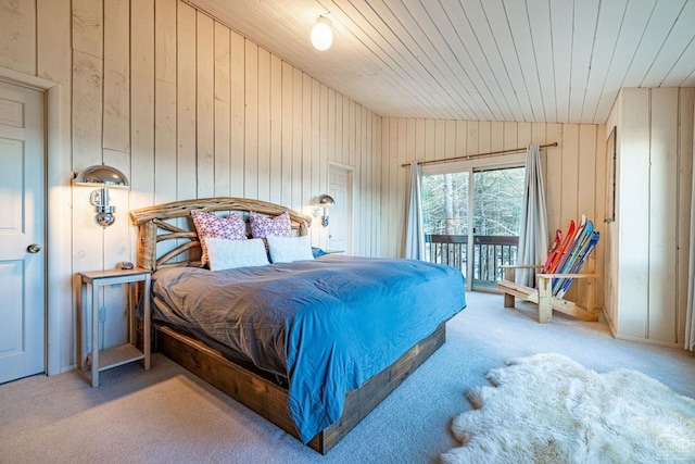 bedroom featuring wood ceiling, vaulted ceiling, wooden walls, carpet, and access to outside