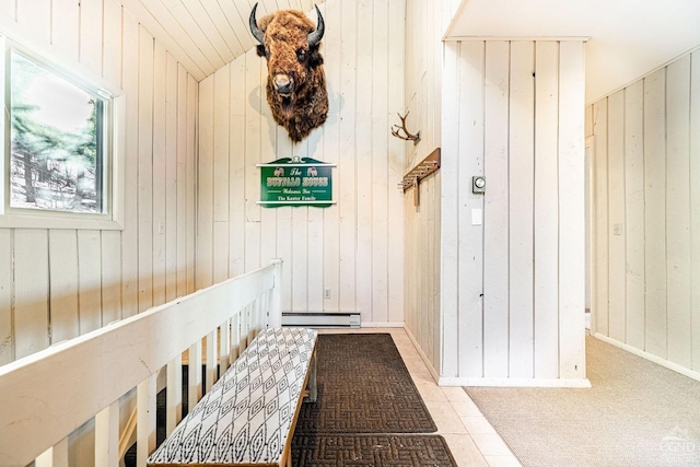 hallway featuring wooden walls