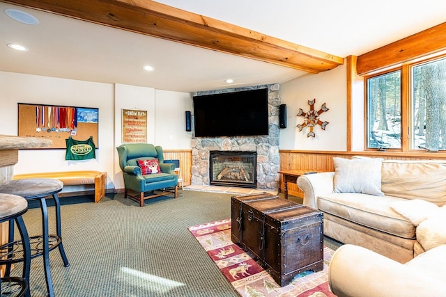 carpeted living room featuring a fireplace and beamed ceiling