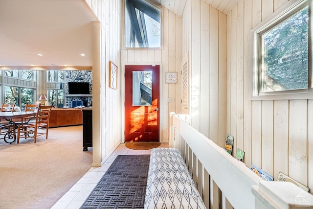 interior space featuring wooden walls and light carpet