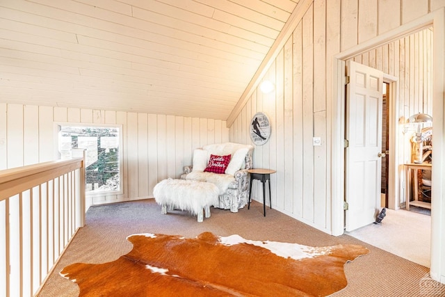 carpeted bedroom with vaulted ceiling and wood walls