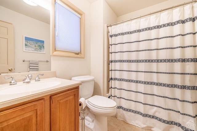 bathroom featuring vanity, tile patterned flooring, toilet, and walk in shower