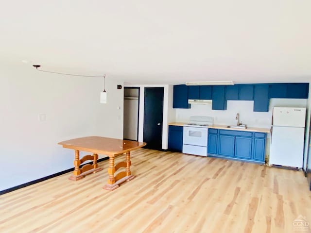 kitchen with white appliances, blue cabinets, sink, decorative light fixtures, and light hardwood / wood-style floors