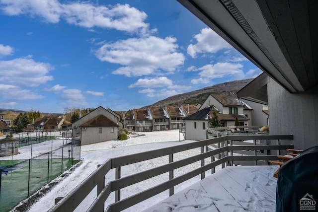 view of snow covered back of property