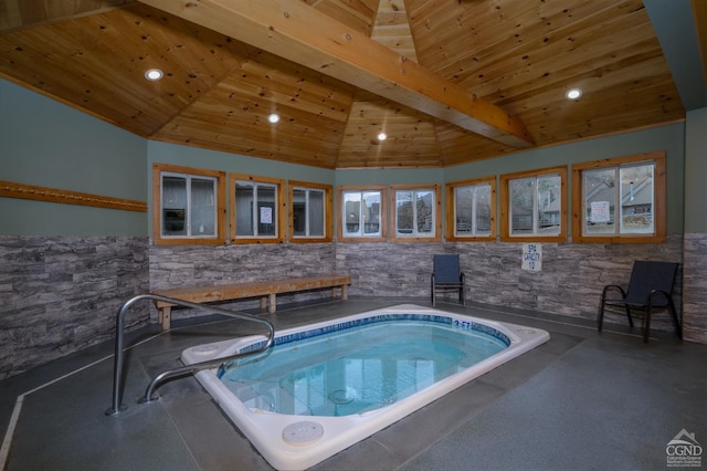 view of swimming pool with an indoor hot tub