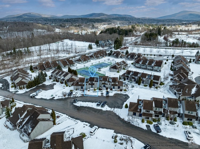 snowy aerial view with a mountain view