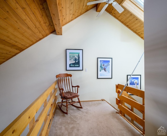 living area with ceiling fan, light colored carpet, wooden ceiling, and vaulted ceiling with beams