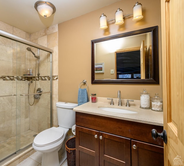 bathroom with tile patterned floors, vanity, toilet, and an enclosed shower