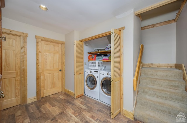 laundry room with dark hardwood / wood-style floors and washing machine and clothes dryer