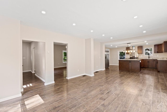 unfurnished living room with dark hardwood / wood-style flooring