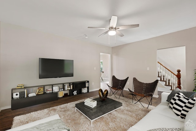 living room featuring wood-type flooring and ceiling fan