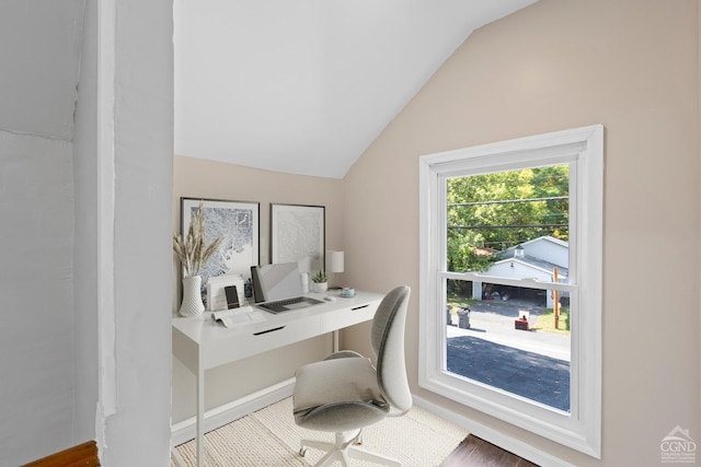 home office with hardwood / wood-style floors and lofted ceiling