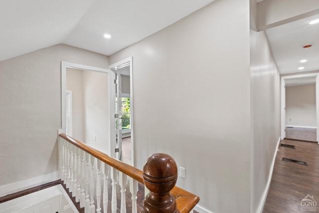 hallway featuring wood-type flooring and vaulted ceiling