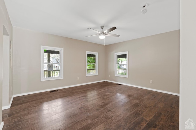 spare room featuring ceiling fan and dark wood-type flooring