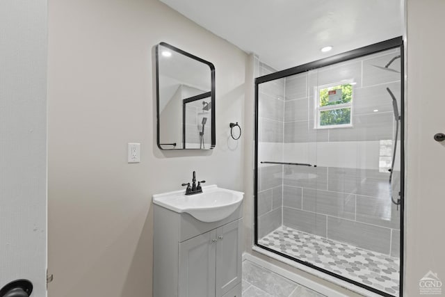 bathroom featuring vanity and an enclosed shower