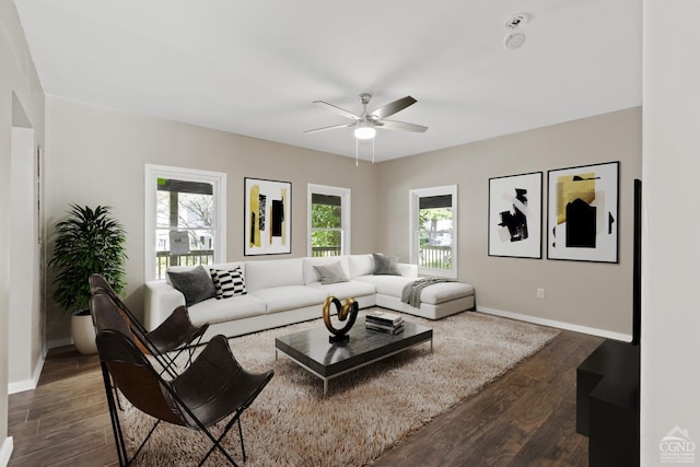 living room with ceiling fan and dark wood-type flooring