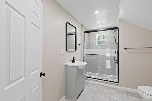 bathroom featuring vanity, toilet, and an enclosed shower