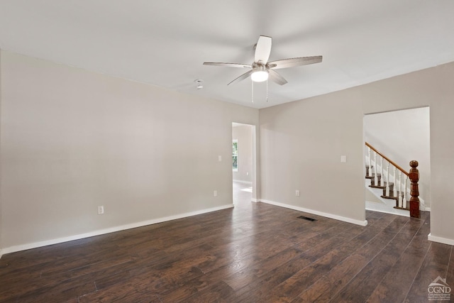 empty room with ceiling fan and dark hardwood / wood-style flooring