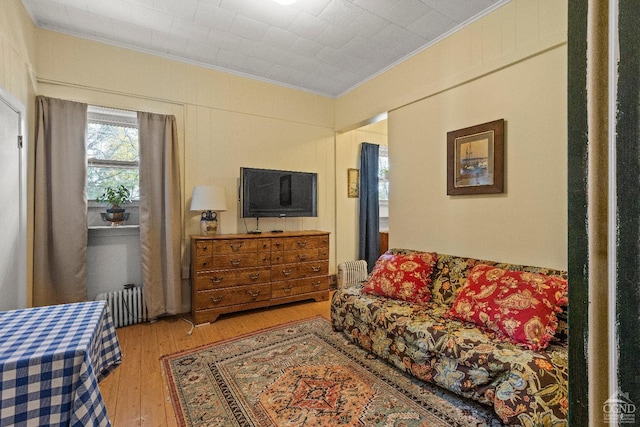 living room with hardwood / wood-style flooring and ornamental molding