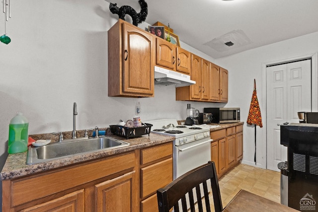 kitchen featuring white stove and sink