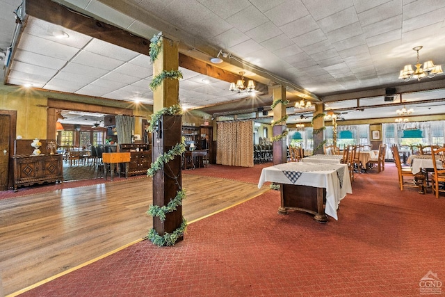 playroom with hardwood / wood-style floors and a notable chandelier