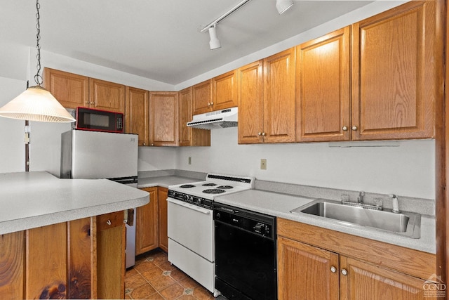 kitchen featuring sink, track lighting, decorative light fixtures, black appliances, and dark tile patterned flooring