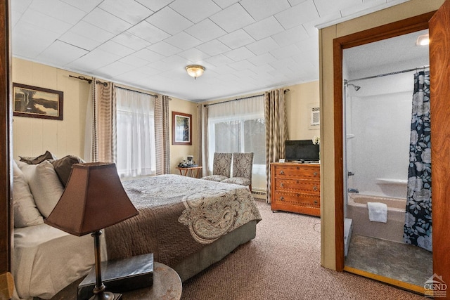 carpeted bedroom with a baseboard heating unit