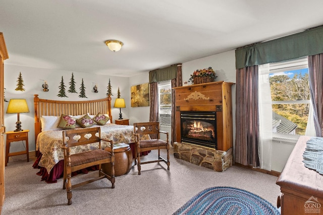 carpeted bedroom with a fireplace