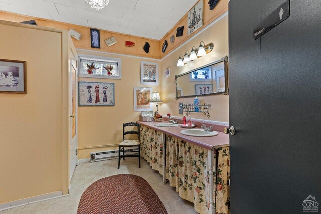 bathroom featuring tile patterned flooring, vanity, and a baseboard radiator