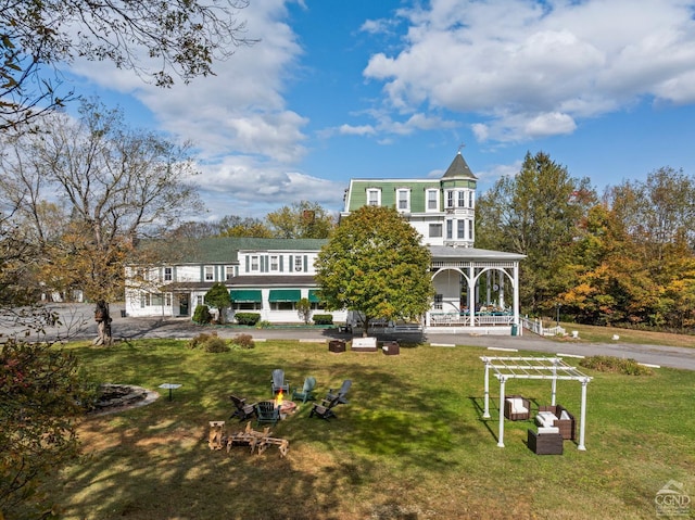 rear view of property featuring a lawn