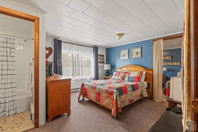 carpeted bedroom featuring a baseboard heating unit