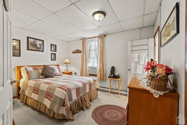 bedroom with a drop ceiling, cooling unit, baseboard heating, and light carpet