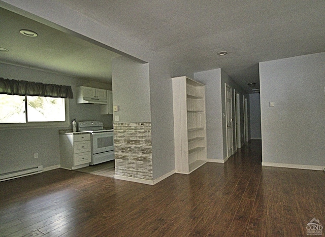 unfurnished room featuring dark hardwood / wood-style floors, a baseboard radiator, and sink