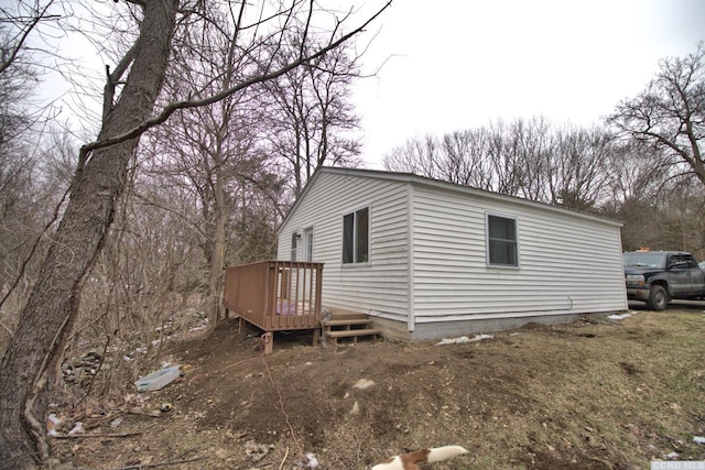 view of home's exterior featuring a wooden deck