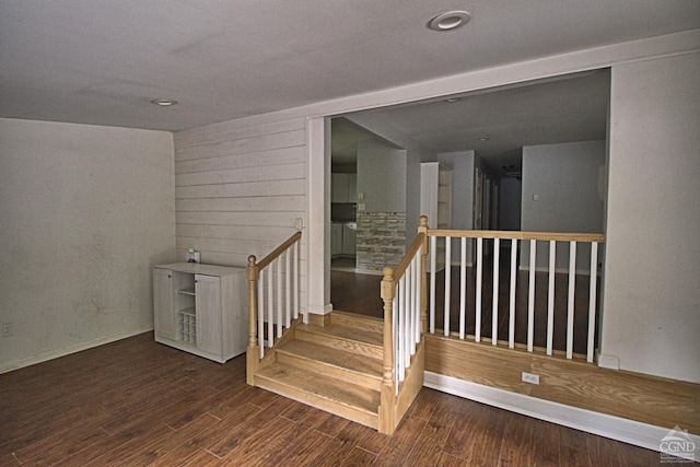 staircase with wood-type flooring