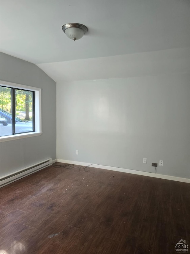 unfurnished room featuring a baseboard heating unit, dark wood-type flooring, and vaulted ceiling