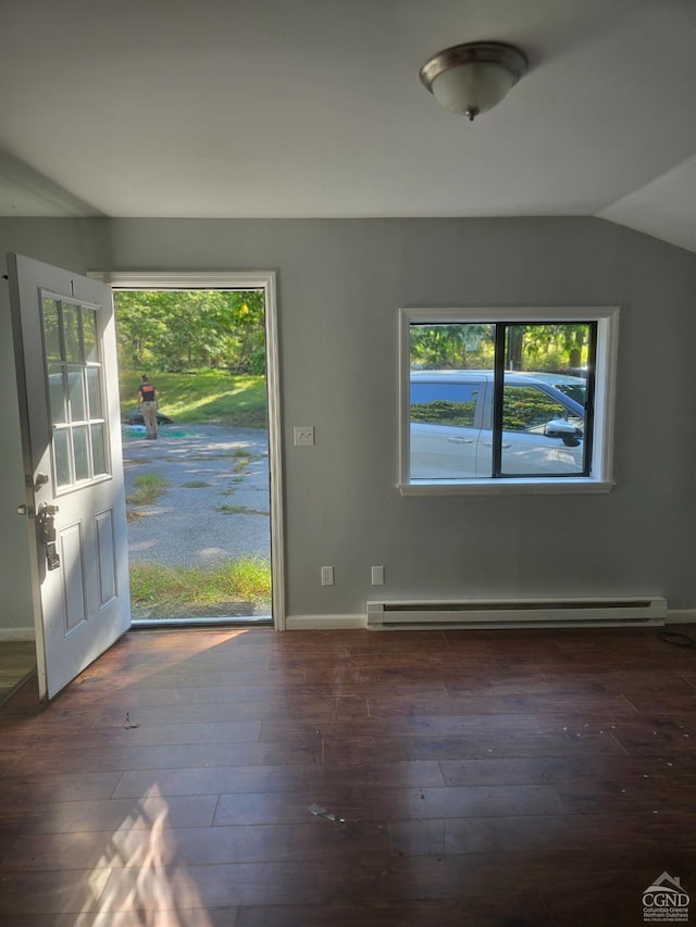 interior space with baseboard heating, plenty of natural light, dark wood-type flooring, and vaulted ceiling